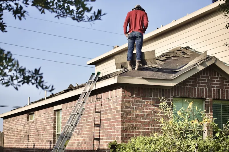 Professional roofer working on a residential roof in Severna Forest